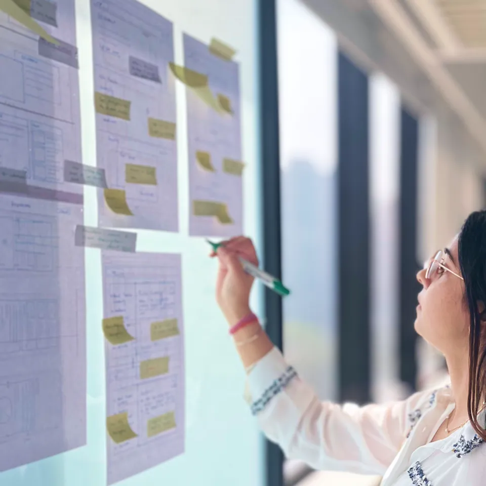 UX Research and Mapping for 360 ONE Teammate reviewing customer journey maps and sticky notes during UX design for the 360 ONE Asset Management website.