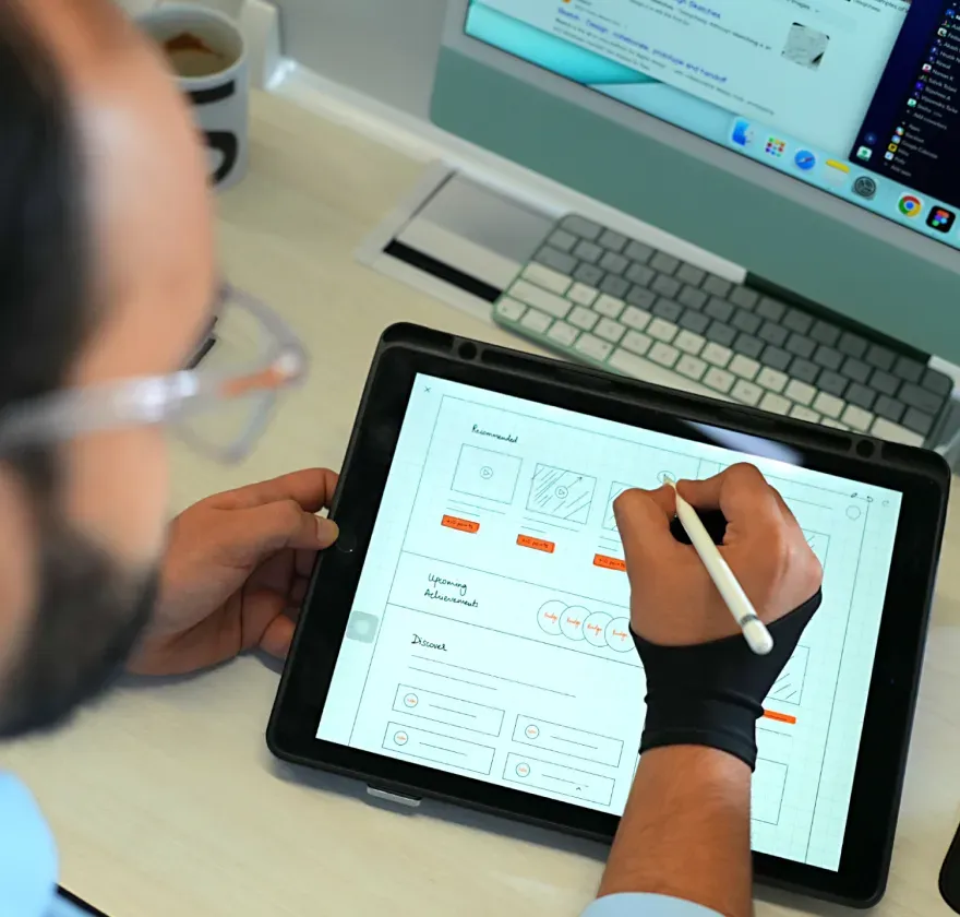 Fully App Wireframes Designer sketching wellness app wireframes on a tablet.