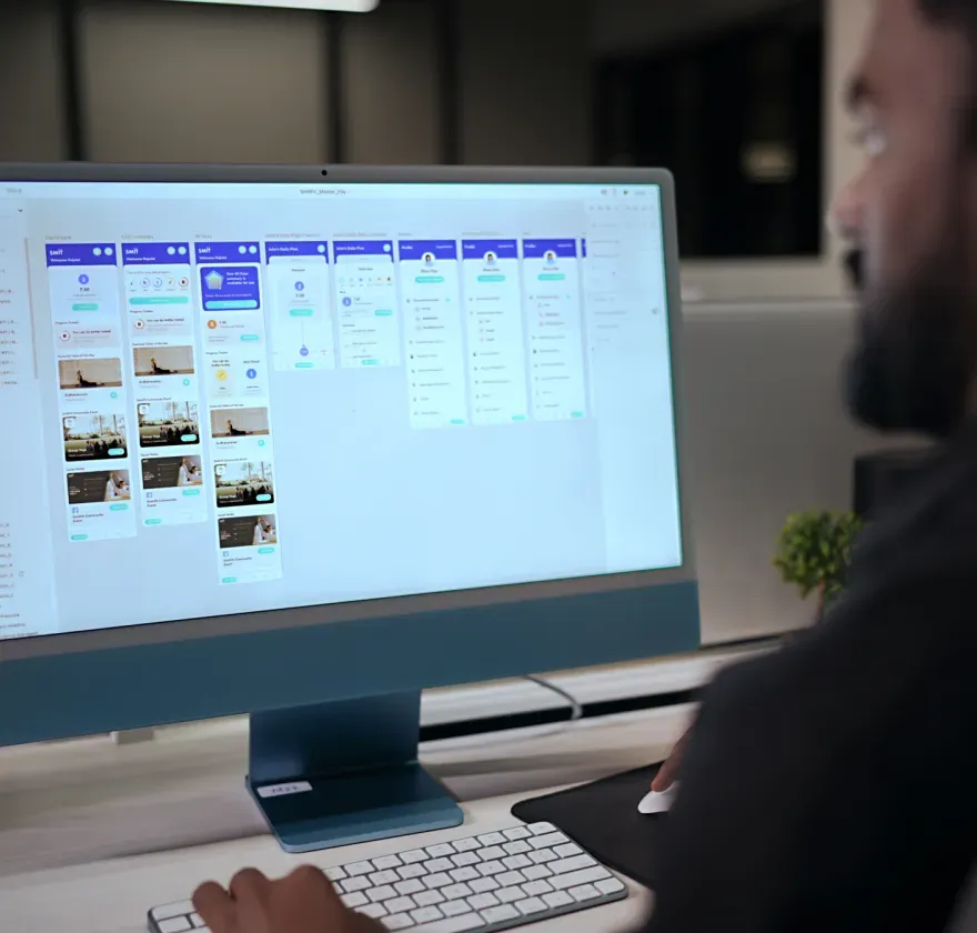 Smit.fit Research Review Designer reviewing Smit.fit mobile app flows on a desktop screen during the UX research phase.