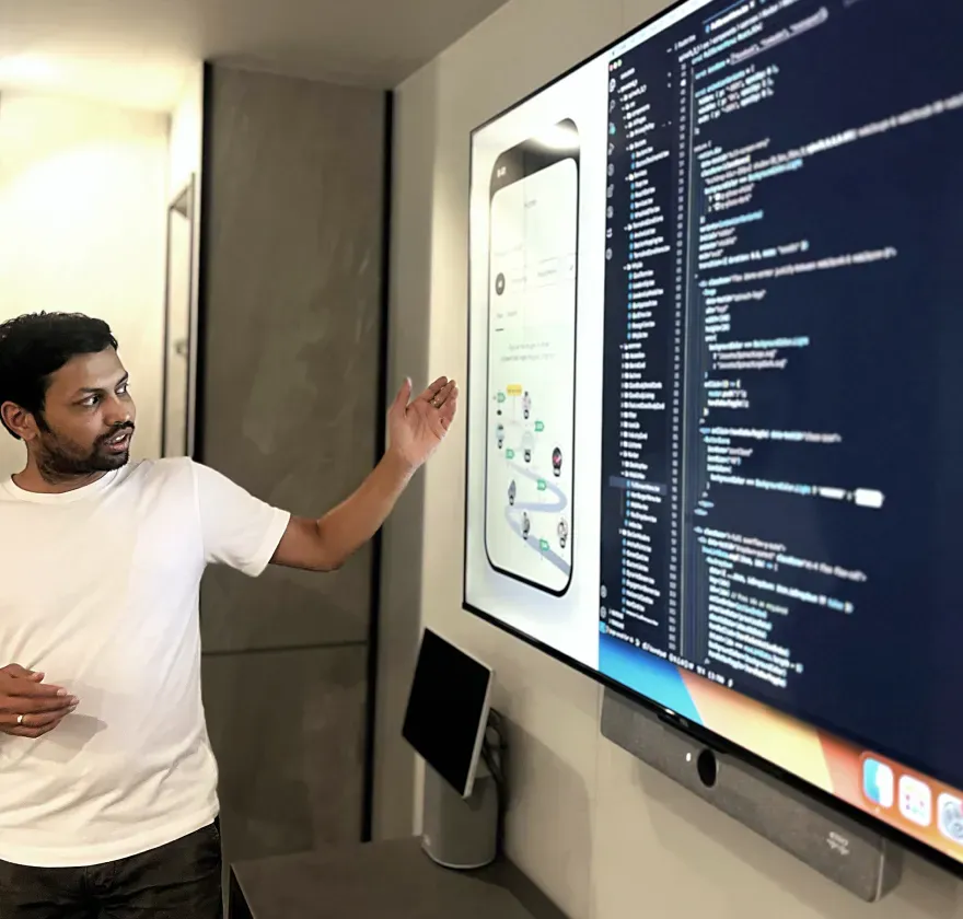 Flow App Engineering Review Team member presenting Flow App interface and code on a large display during review.